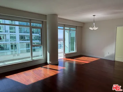 a view of a building with a swimming pool and sitting area