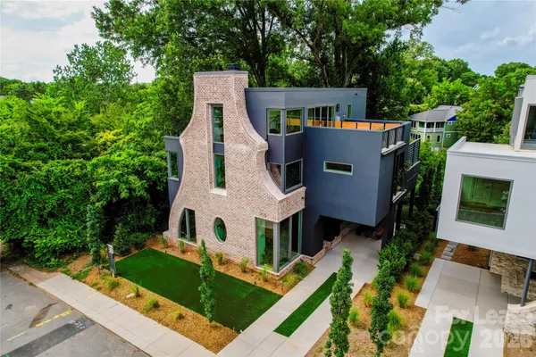 an aerial view of a house with garden space and street view