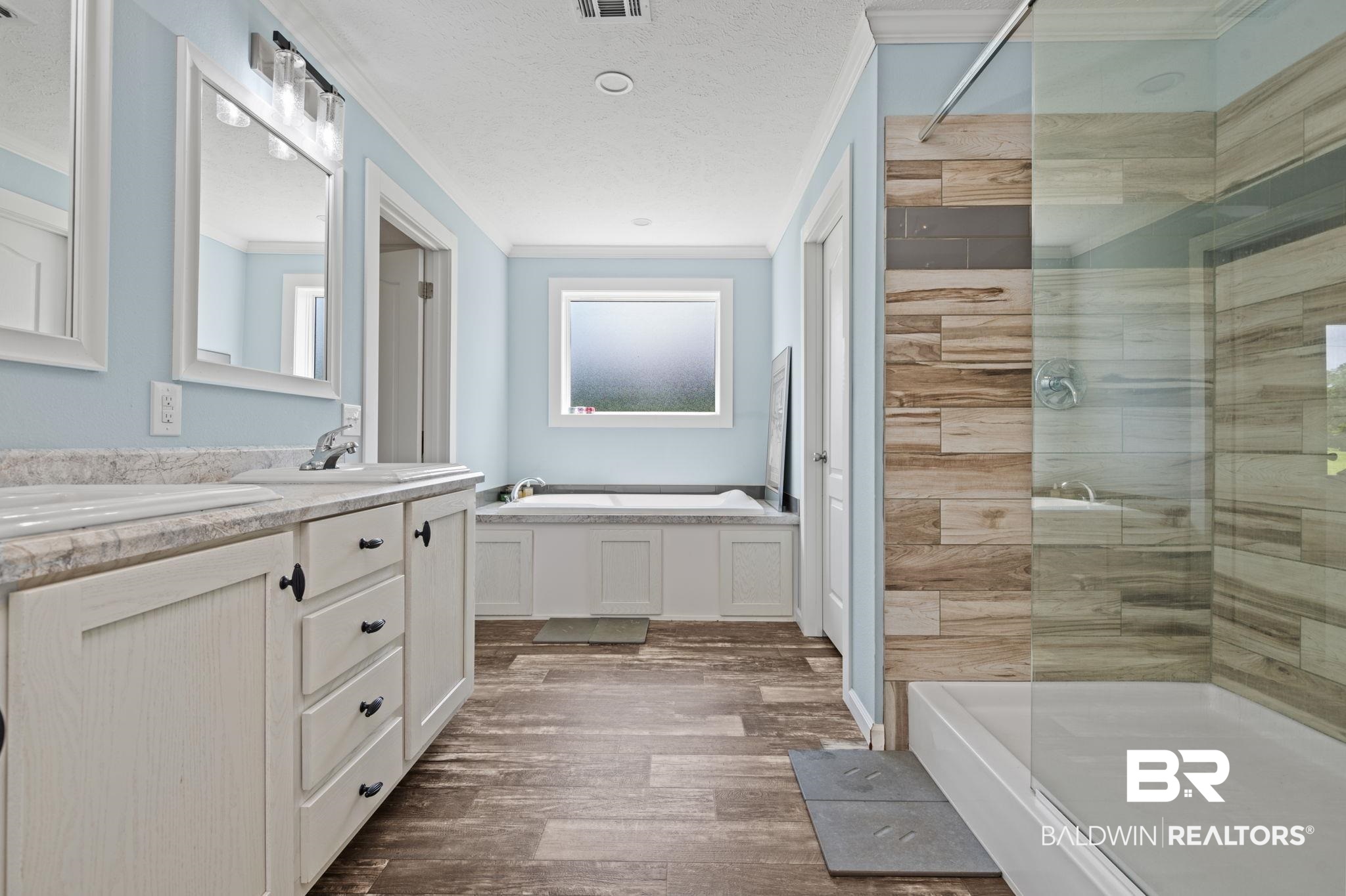 10703 South Ridge Drive Semmes, AL 36575 - Photo 22 of 37 Bathroom featuring a bath, ornamental molding, double vanity, a tile shower, and wood finished floors