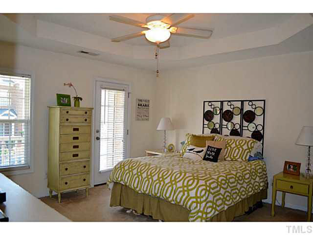 1364 Regulator Street Raleigh, NC 27603 - Photo 14 of 24 a bedroom with a bed and a chandelier