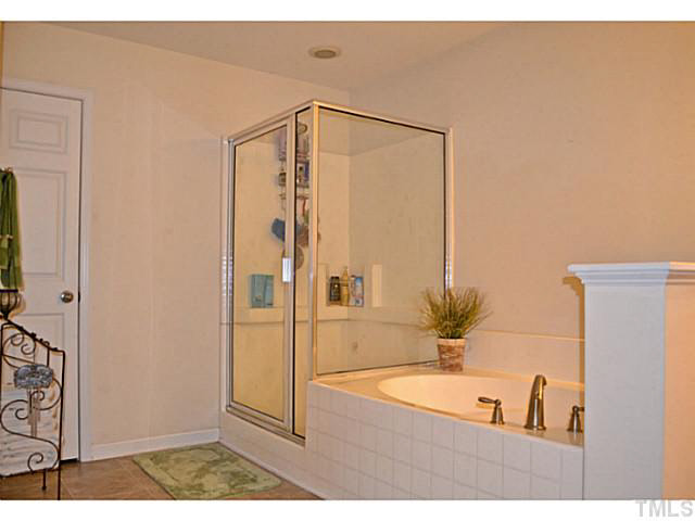 1364 Regulator Street Raleigh, NC 27603 - Photo 16 of 24 a bathroom with a bathtub and a shower