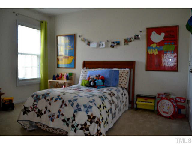 1364 Regulator Street Raleigh, NC 27603 - Photo 18 of 24 a bedroom with a bed next to a window