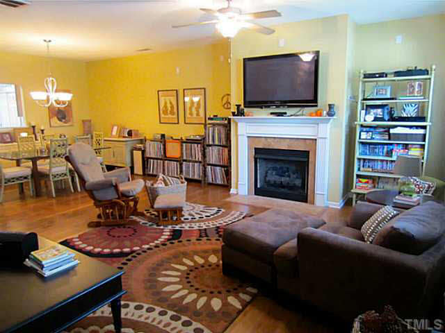 1364 Regulator Street Raleigh, NC 27603 - Photo 24 of 24 a living room with furniture a flat screen tv and a fireplace