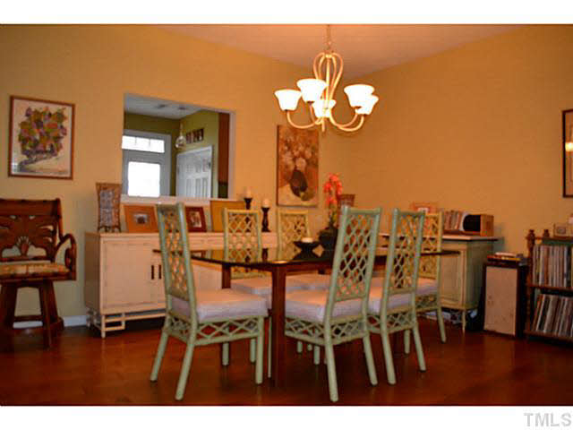 1364 Regulator Street Raleigh, NC 27603 - Photo 6 of 24 a view of a dining room with furniture and wooden floor
