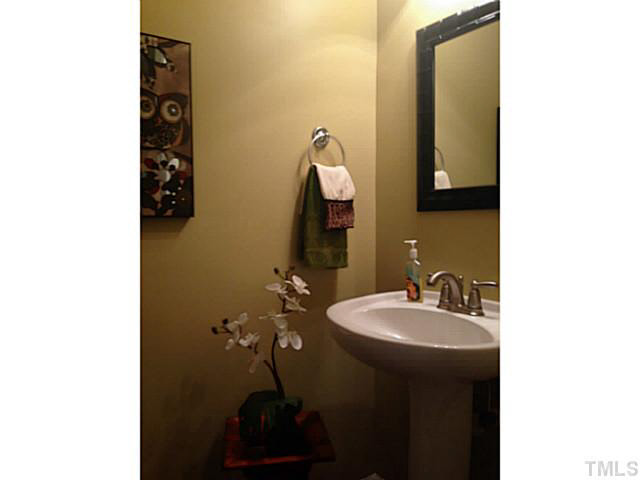 1364 Regulator Street Raleigh, NC 27603 - Photo 8 of 24 a bathroom with a sink and a mirror