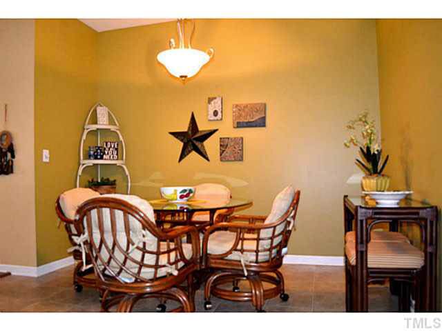 1364 Regulator Street Raleigh, NC 27603 - Photo 9 of 24 a view of a dining room with furniture and chandelier