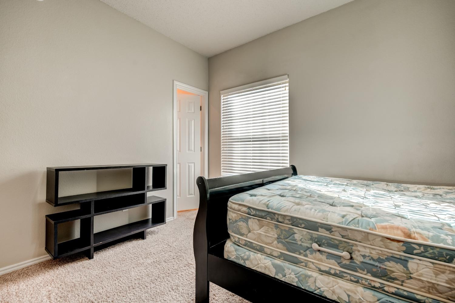 2102 Main Street, Unit 5 Lubbock, TX 79401 - Photo 20 of 27 a bedroom with a bed and a window