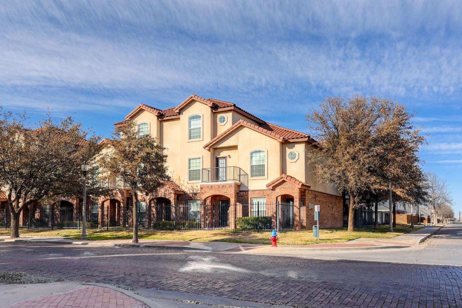 2102 Main Street, Unit 5 Lubbock, TX 79401 - Photo 2 of 27 a front view of a house with a yard