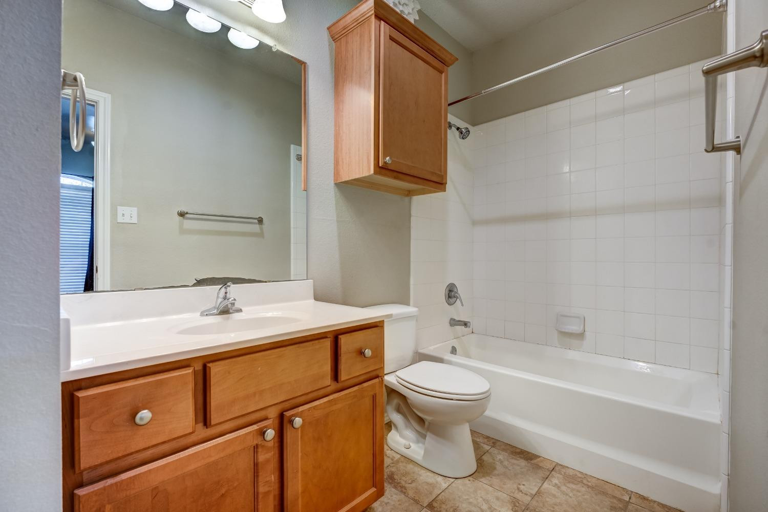 2102 Main Street, Unit 5 Lubbock, TX 79401 - Photo 23 of 27 a bathroom with a sink a toilet and shower