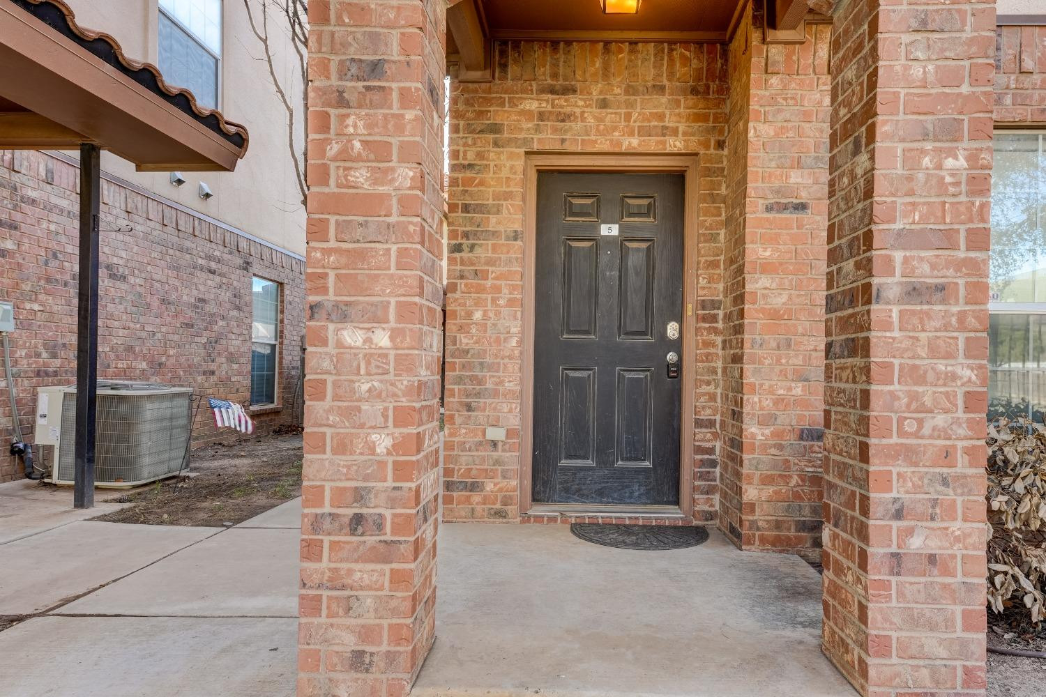 2102 Main Street, Unit 5 Lubbock, TX 79401 - Photo 3 of 27 a view of a brick house with a brick wall