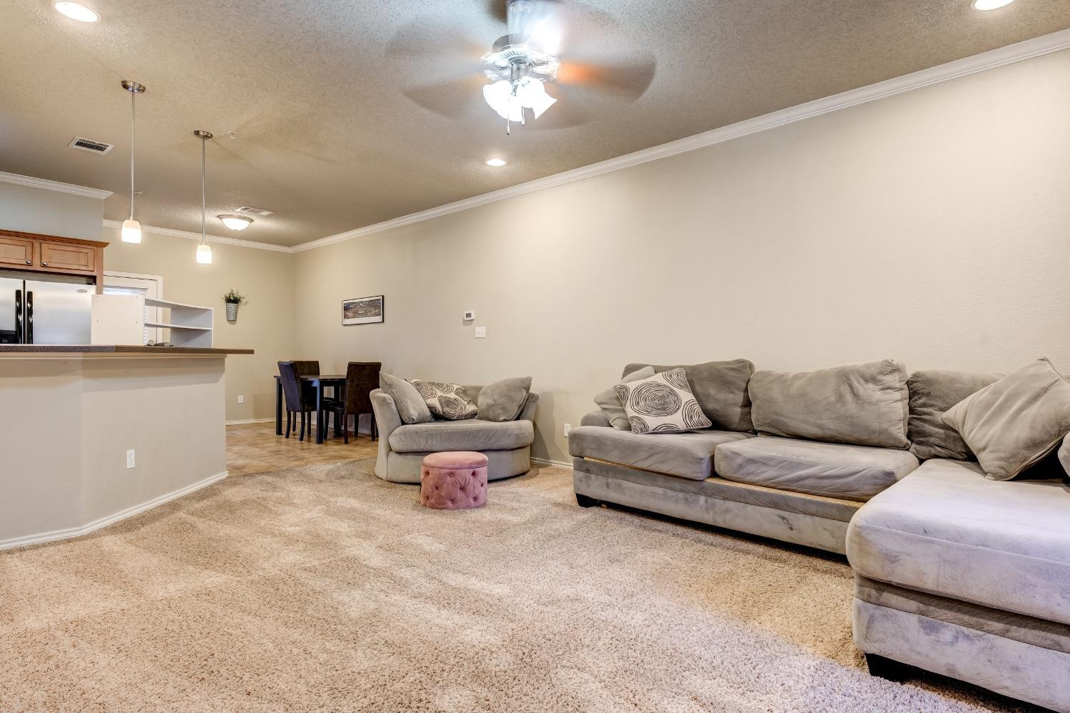 2102 Main Street, Unit 5 Lubbock, TX 79401 - Photo 7 of 27 a living room with furniture and kitchen view