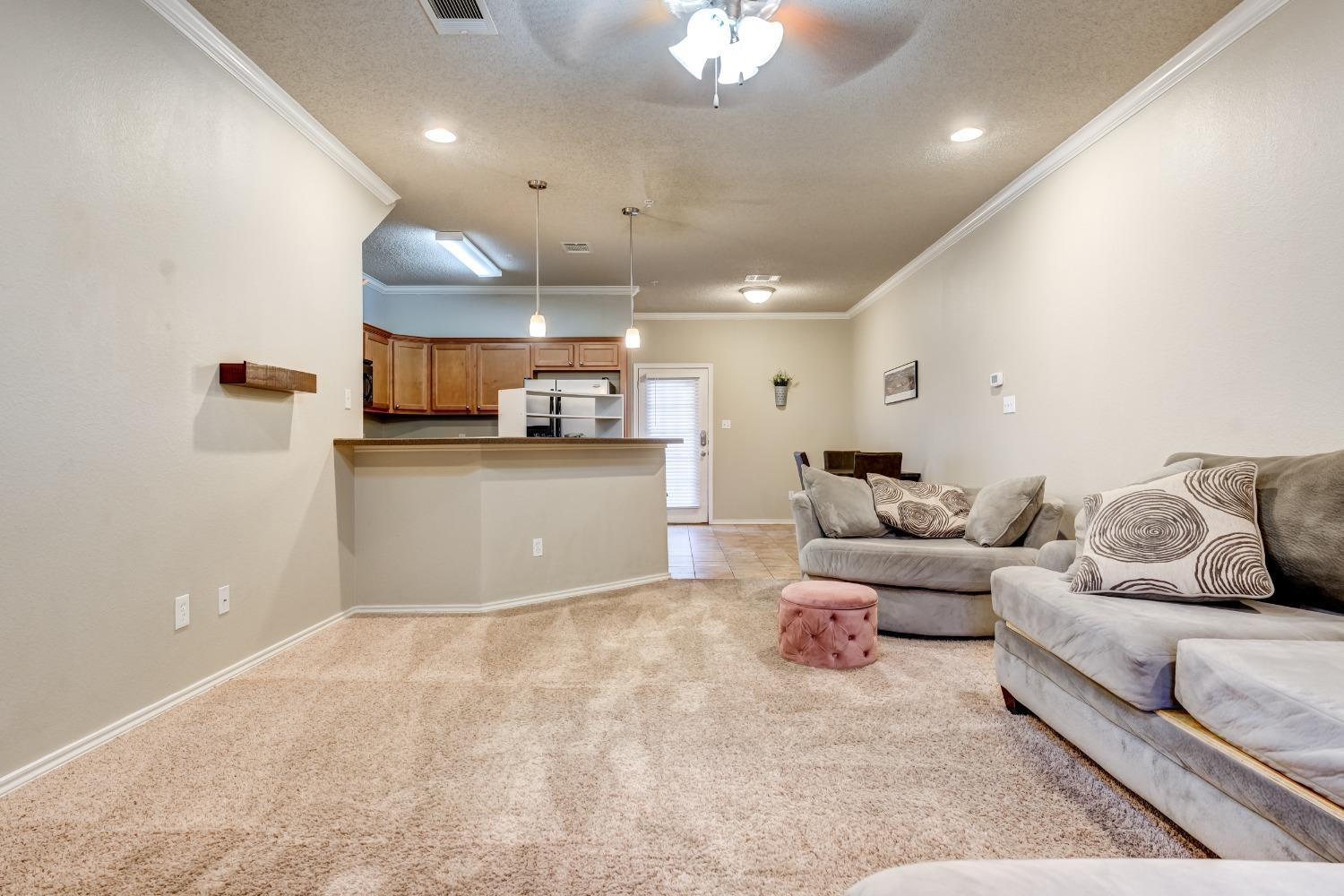 2102 Main Street, Unit 5 Lubbock, TX 79401 - Photo 8 of 27 a living room with furniture and kitchen view