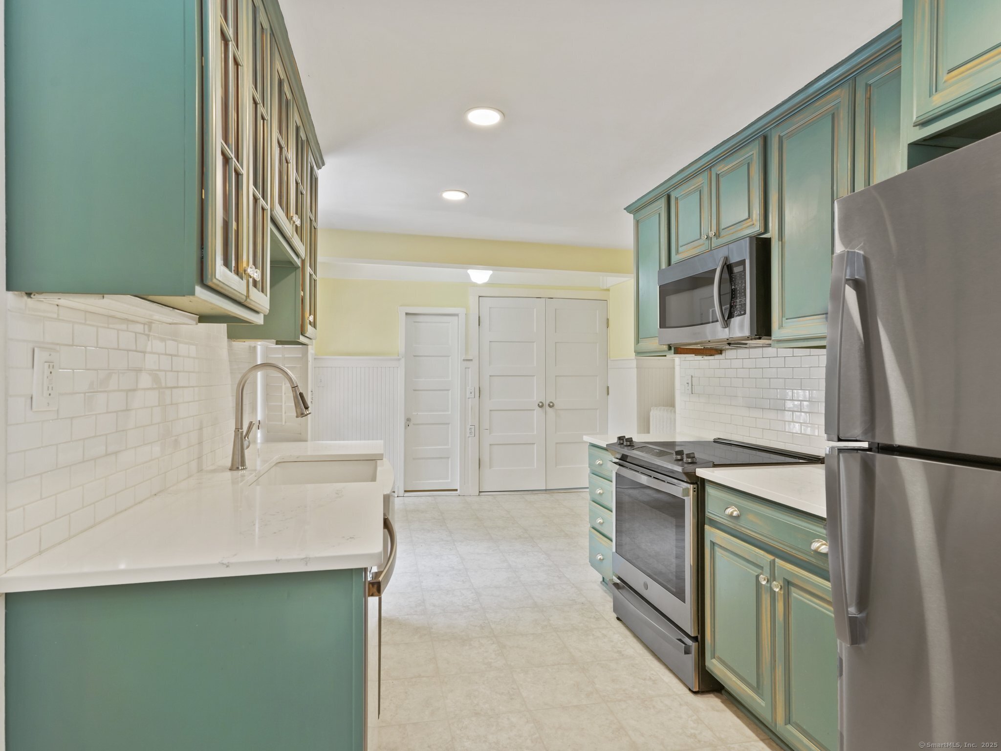 355 Main Street Old Saybrook, CT 06475 - Photo 12 of 29 a kitchen with a sink a refrigerator and a stove top oven