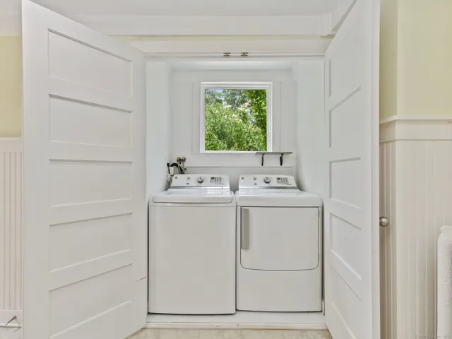 a utility room with closet dryer and washer