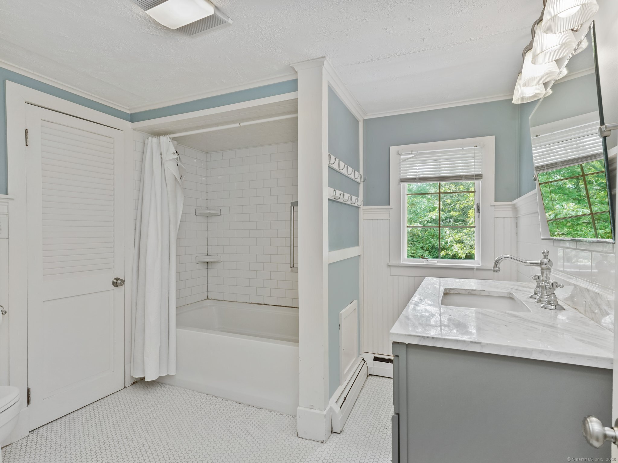 355 Main Street Old Saybrook, CT 06475 - Photo 16 of 29 a bathroom with a shower sink and mirror