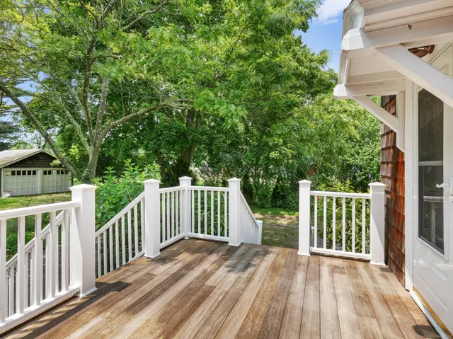 a view of backyard with a deck and wooden floor