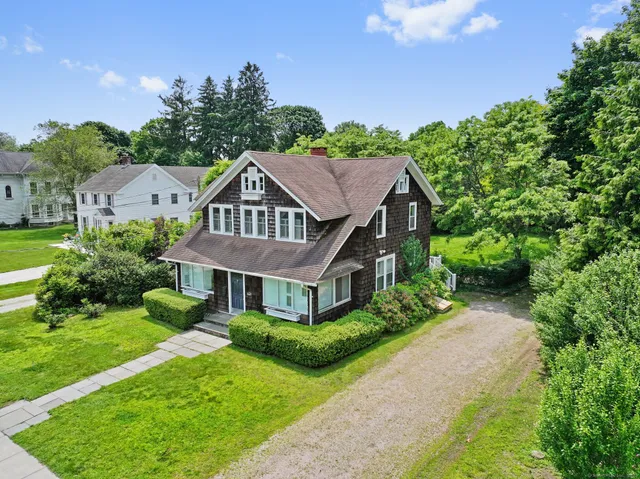 a aerial view of a house with yard and green space