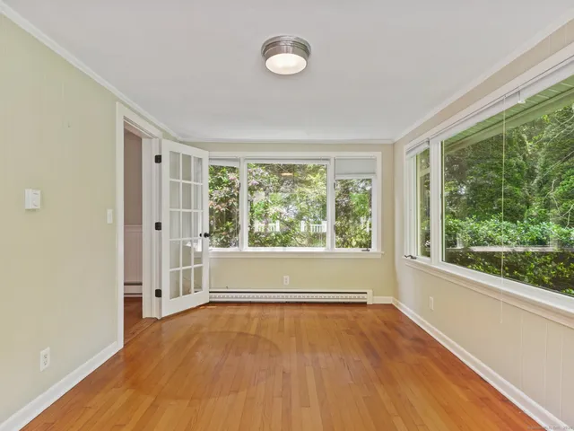 wooden floor in an empty room with a window