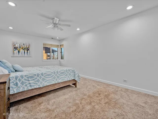 a bed room with a bed and a chandelier