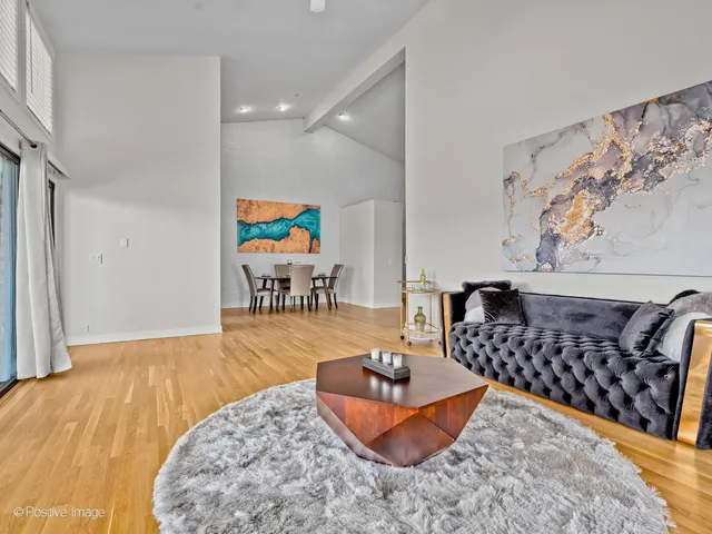 a living room with furniture rug and wooden floor