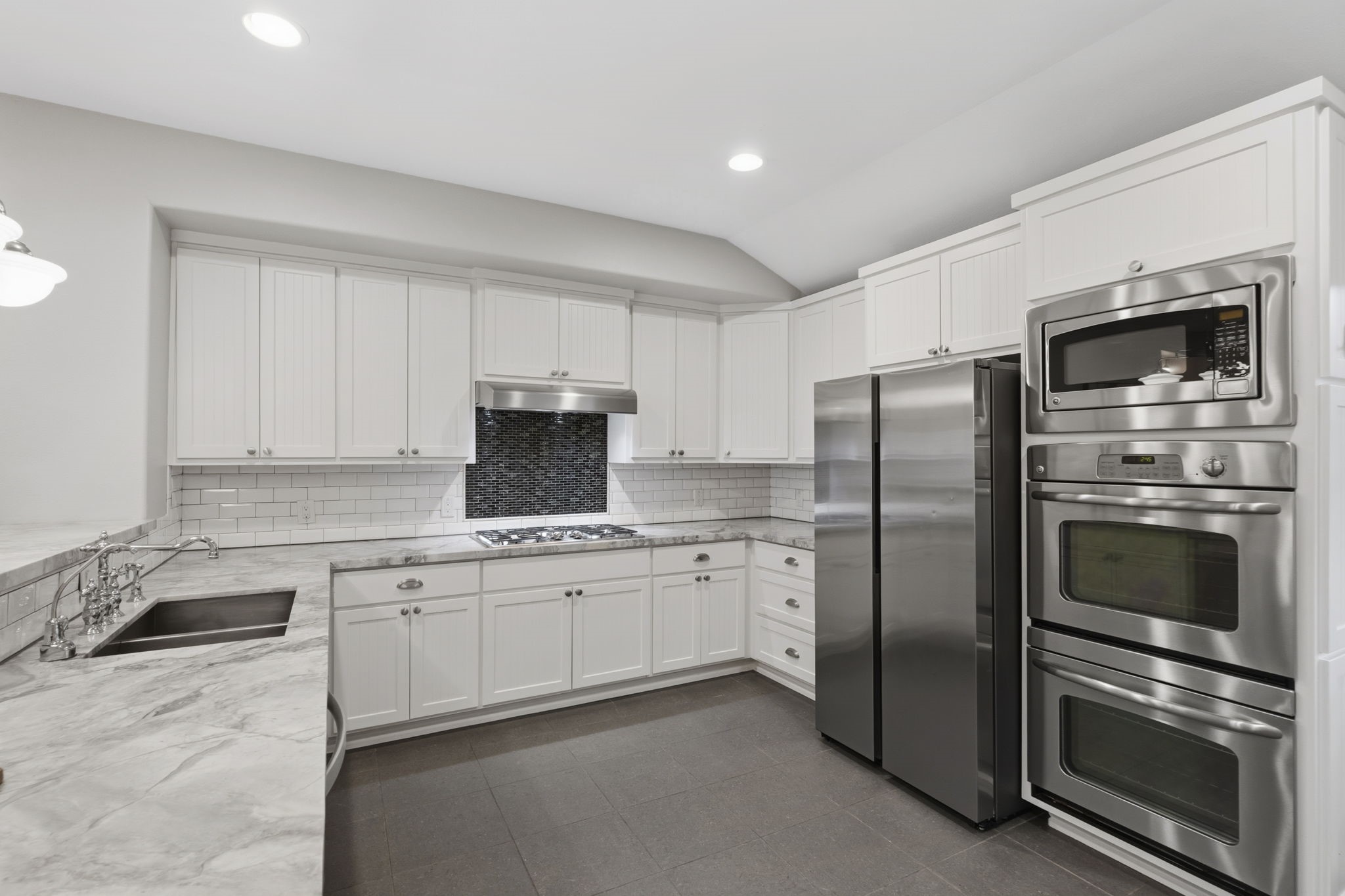 4733 Carleen Road Houston, TX 77092 - Photo 8 of 22 Bright white cabinetry, double ovens, subway tile backsplash, and generous prep space give the kitchen a timeless feel.