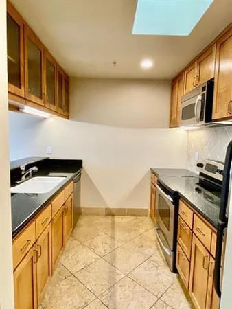 a kitchen that has a sink and a stove