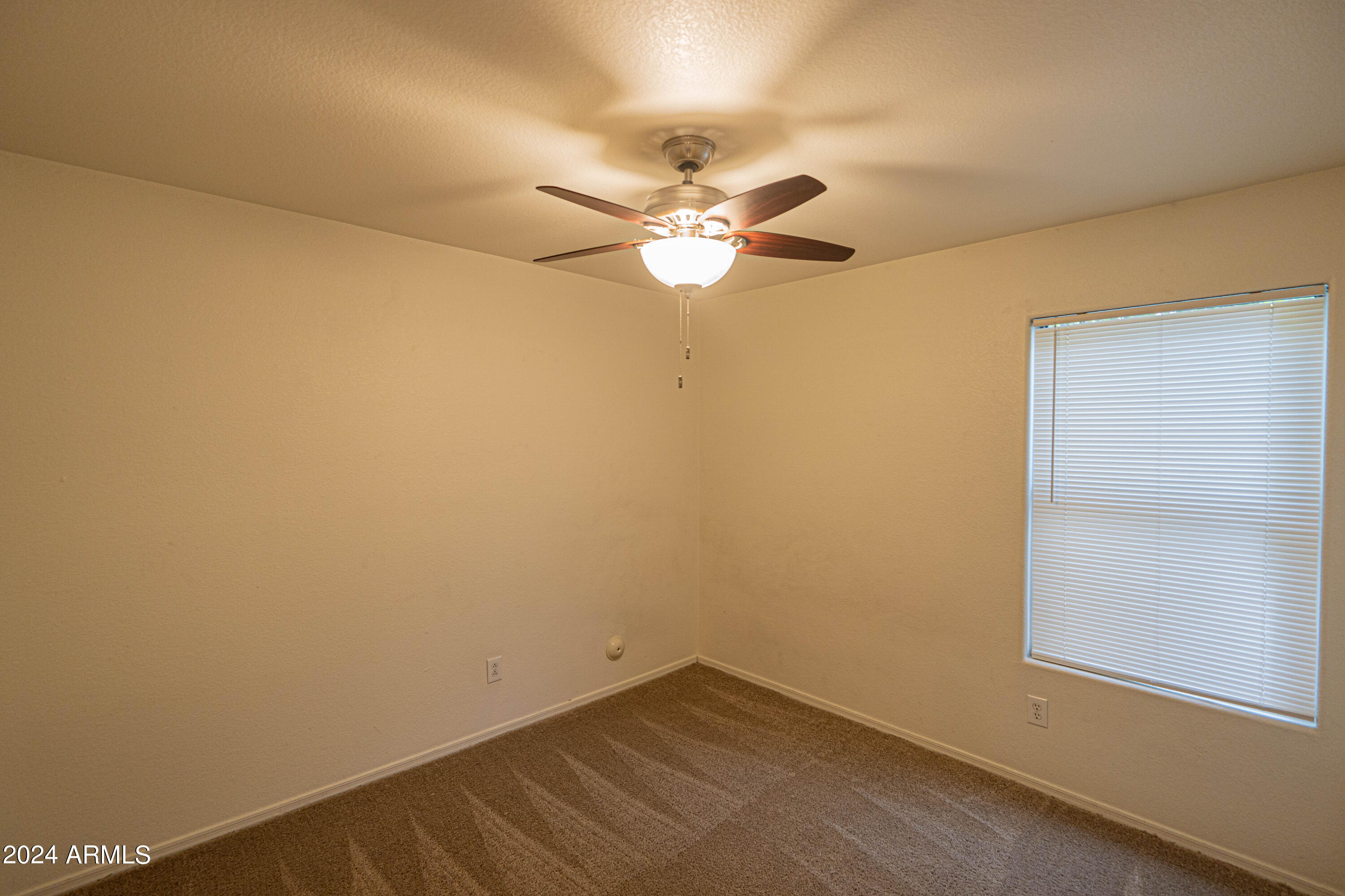 1729 East Del Rio Street Gilbert, AZ 85295 - Photo 13 of 19 an empty room with a ceiling fan and a window
