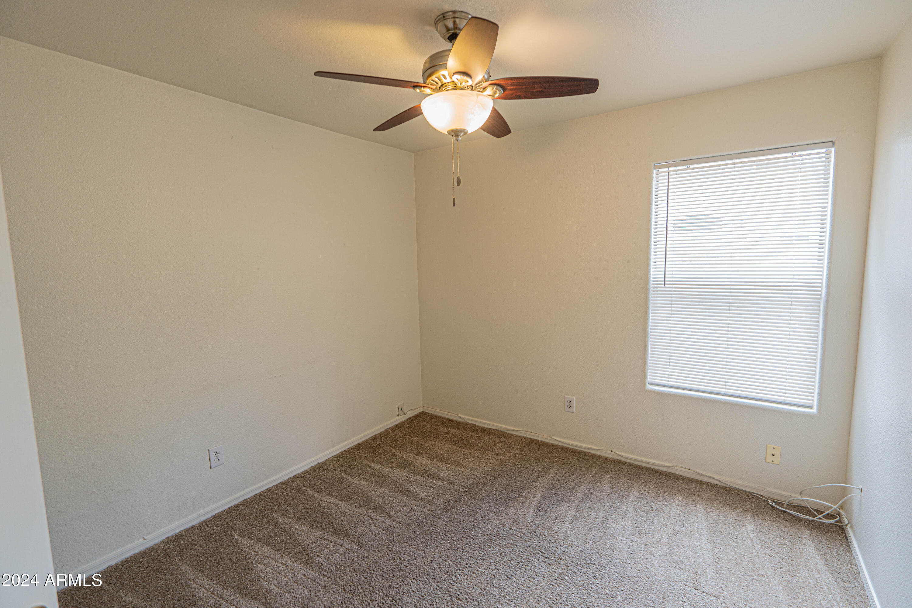 1729 East Del Rio Street Gilbert, AZ 85295 - Photo 15 of 19 an empty room with a window and a fan