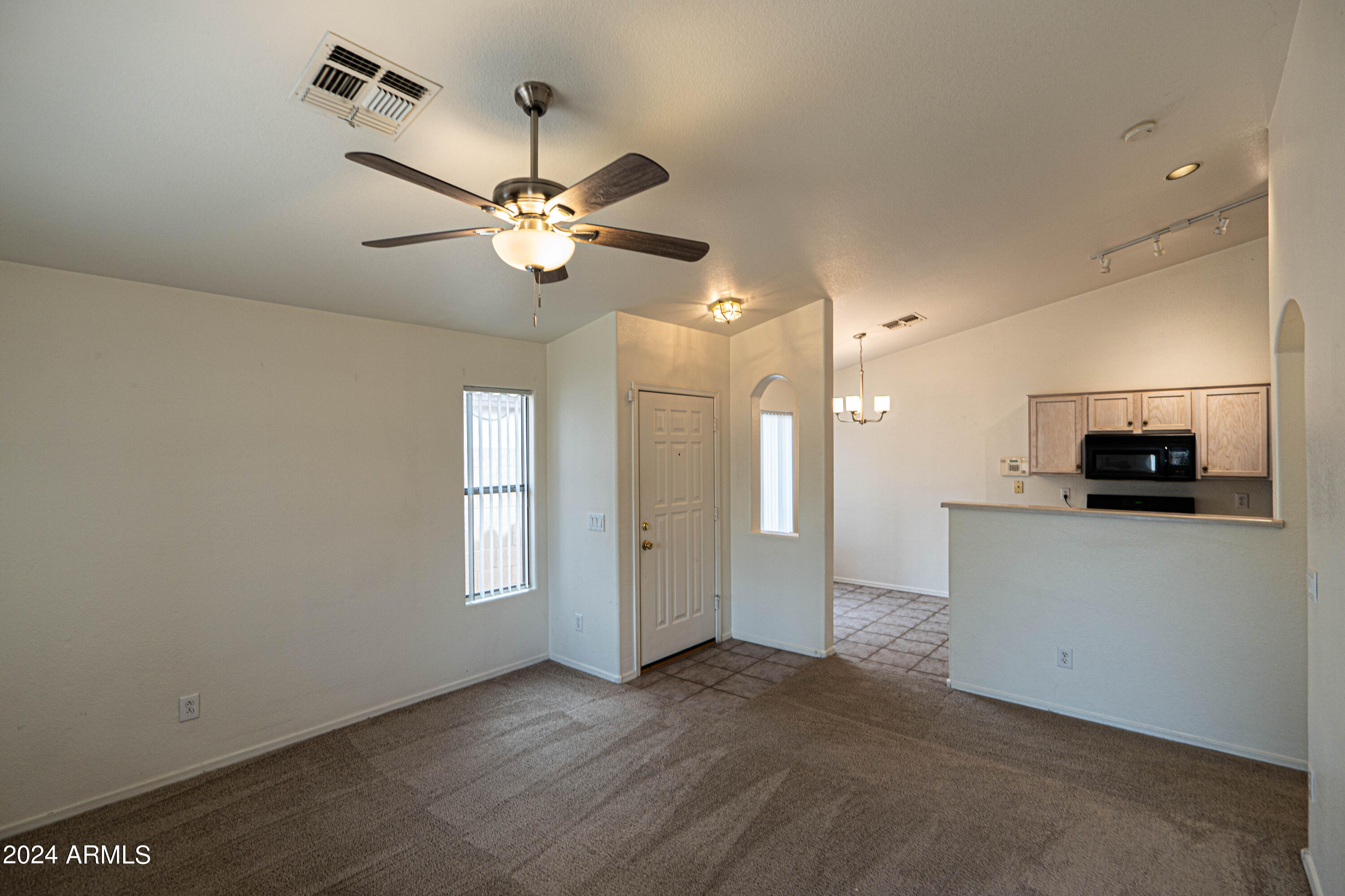 1729 East Del Rio Street Gilbert, AZ 85295 - Photo 3 of 19 a view of a kitchen with a sink and a ceiling fan