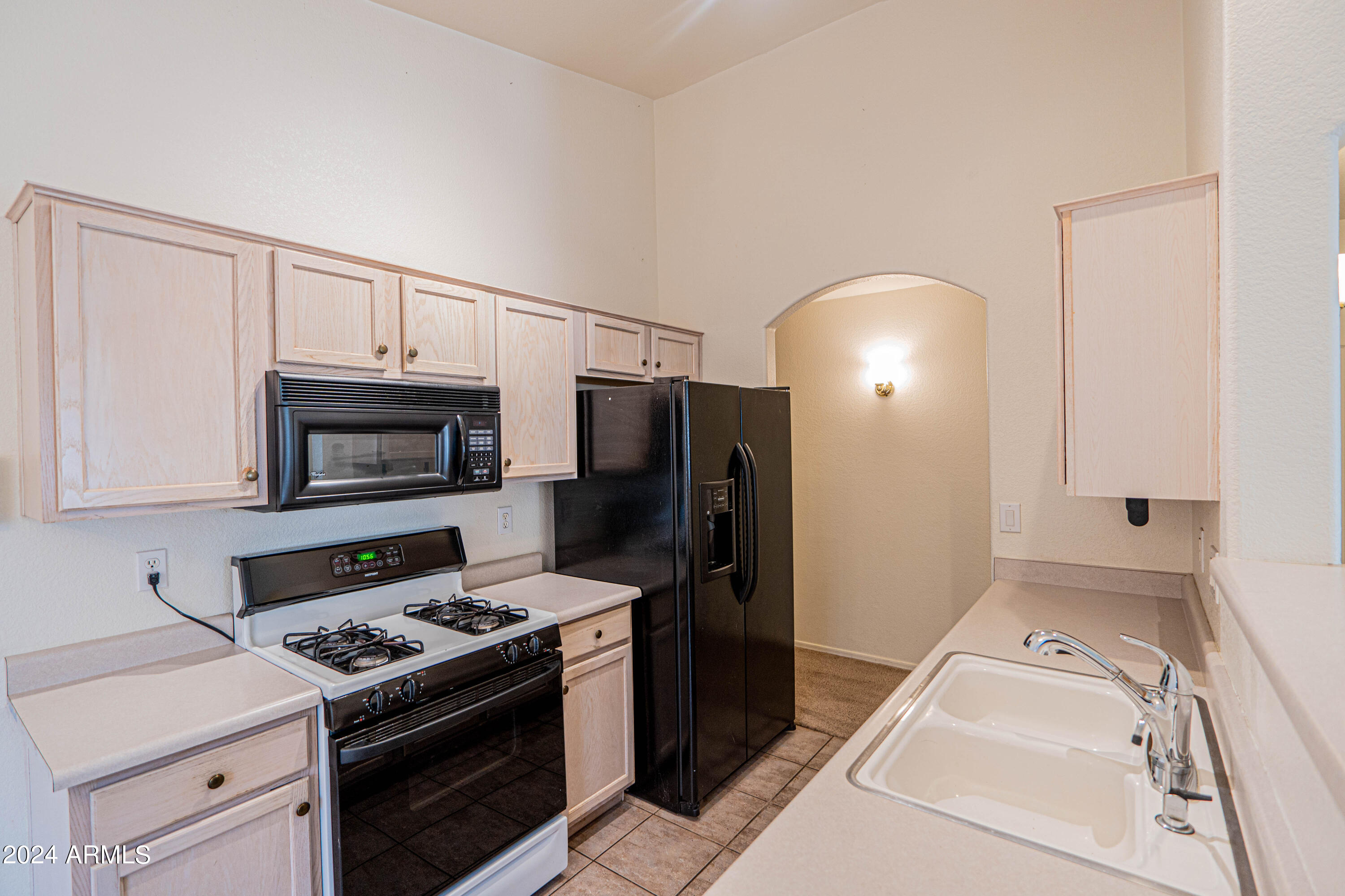1729 East Del Rio Street Gilbert, AZ 85295 - Photo 5 of 19 a kitchen with a stove and a microwave