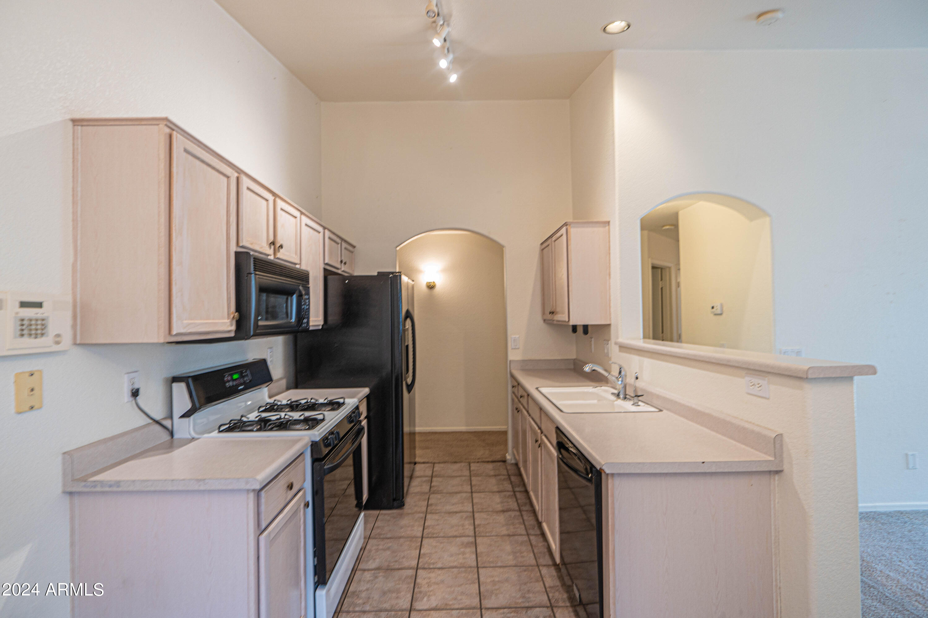 1729 East Del Rio Street Gilbert, AZ 85295 - Photo 7 of 19 a kitchen that has a sink and a stove in it