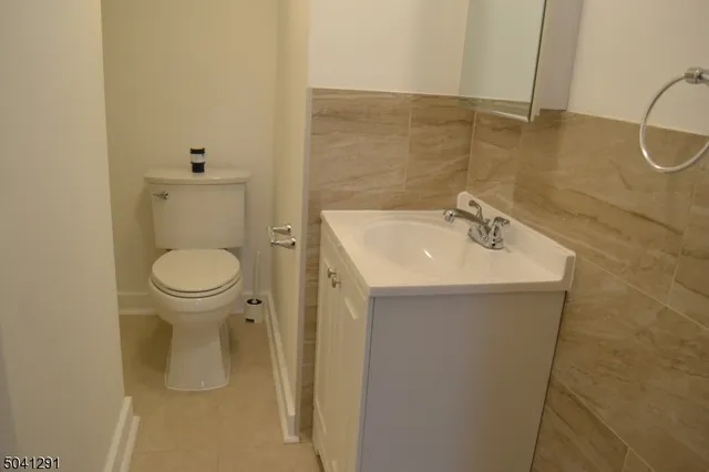 a bathroom with a sink toilet and a mirror