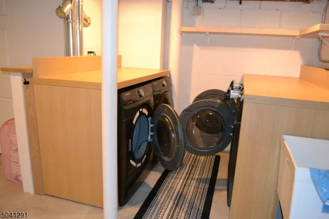 a view of a house with a yard and large trees