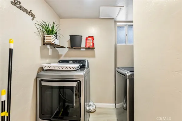 a spacious bedroom with a bed a fireplace and a flat screen tv
