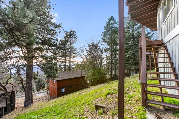 a view of balcony with wooden floor and fence