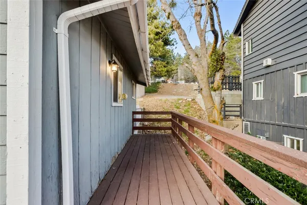 a view of balcony with wooden floor and fence