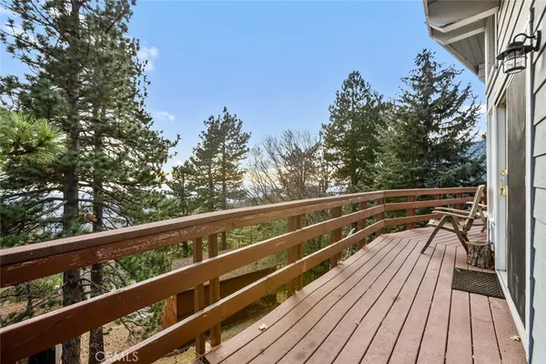 a view of balcony with wooden floor and fence