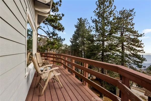 a backyard of a house with a bench and wooden fence