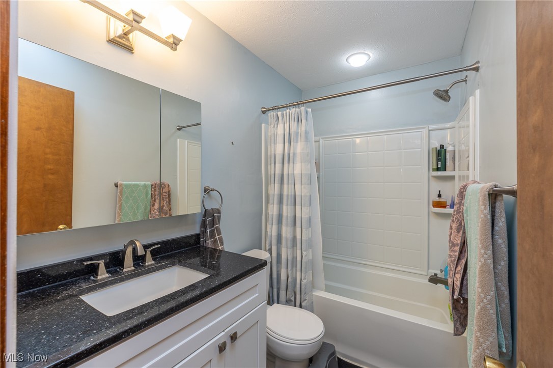 7711 Diagonal Road Kent, OH 44240 - Photo 22 of 45 Full bathroom with vanity and shower / bathtub combination with curtain