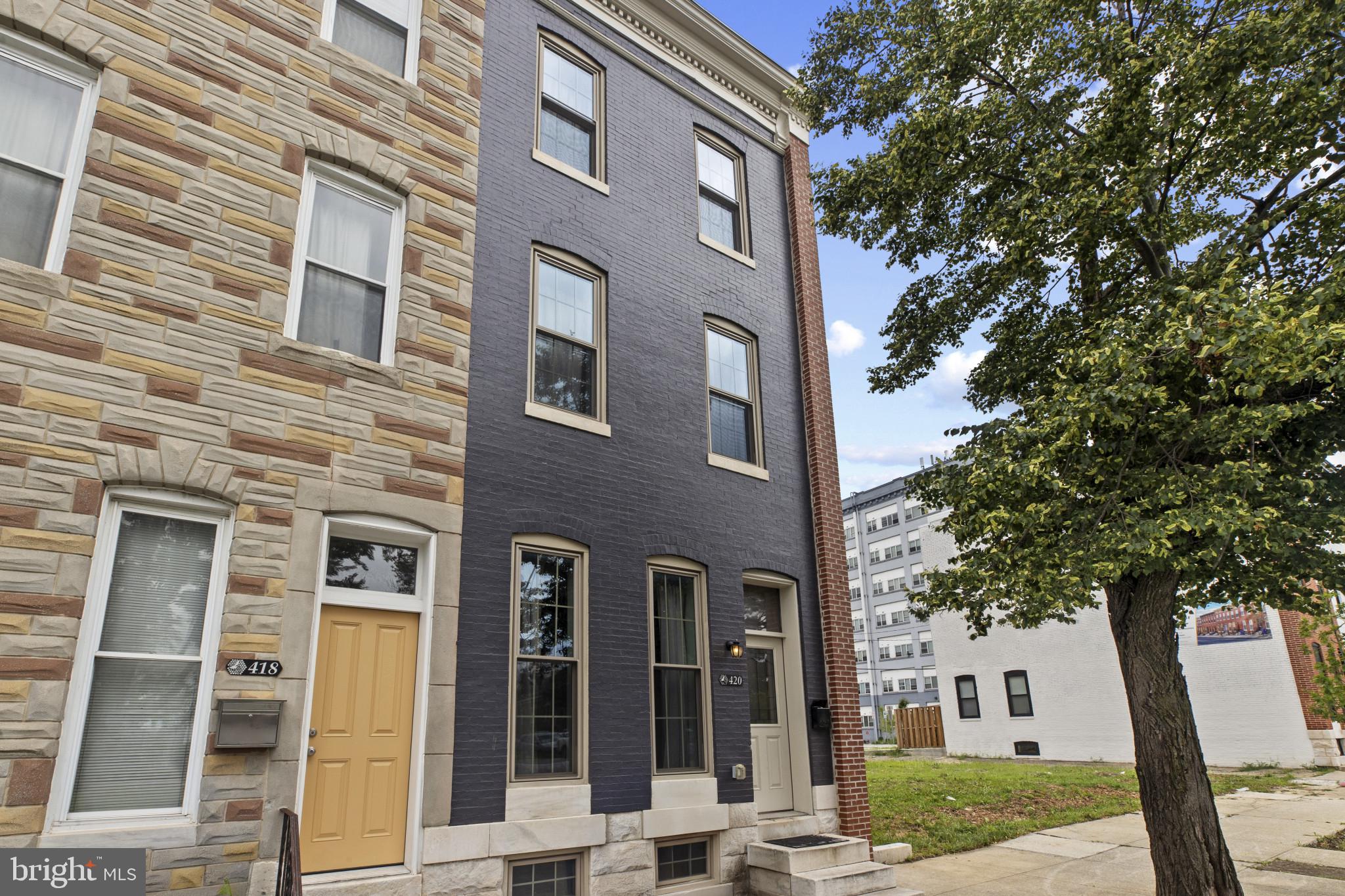 a front view of a building with a garden