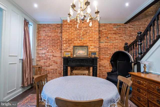 a front view of a house with barbeque and wooden floor