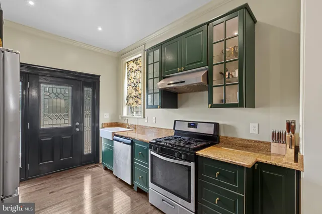 a kitchen with stainless steel appliances granite countertop a stove and a sink