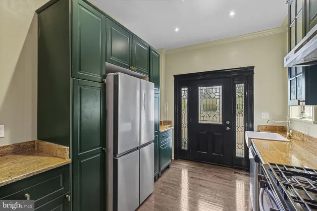 a kitchen with stainless steel appliances granite countertop a refrigerator and a sink