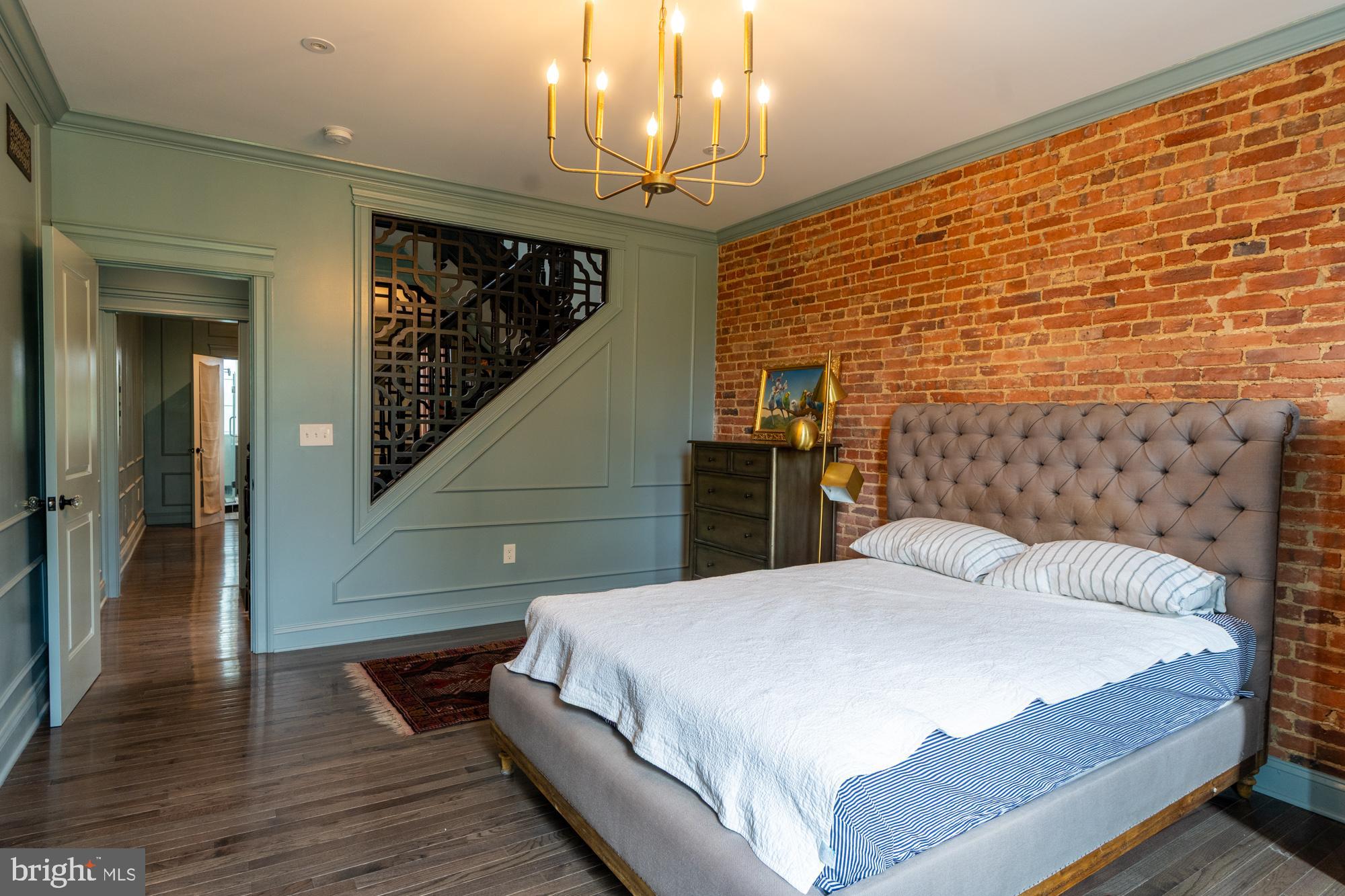 420 East Biddle Street Baltimore, MD 21202 - Photo 21 of 47 a bedroom with a bed and wooden floor