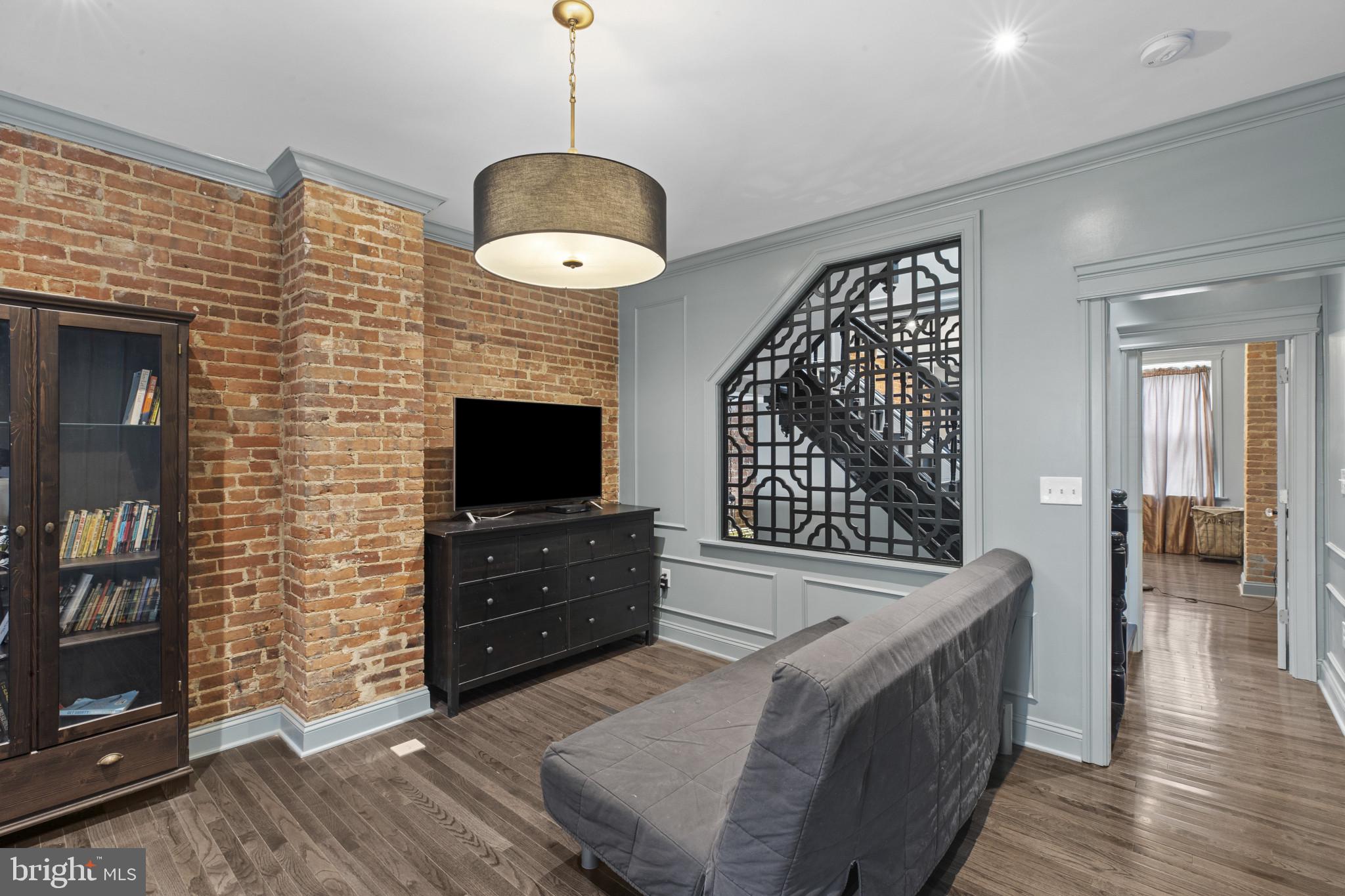 420 East Biddle Street Baltimore, MD 21202 - Photo 22 of 47 a living room with furniture and a fireplace