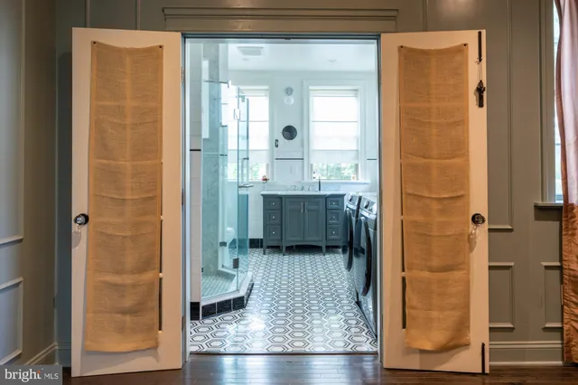a bathroom with a glass shower door and a bathtub