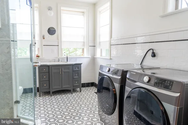 a view of a bathroom with washing machine and windows