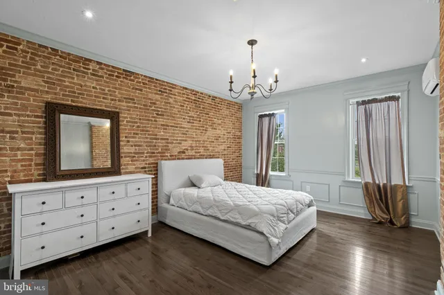 a bedroom with a large bed and a dresser