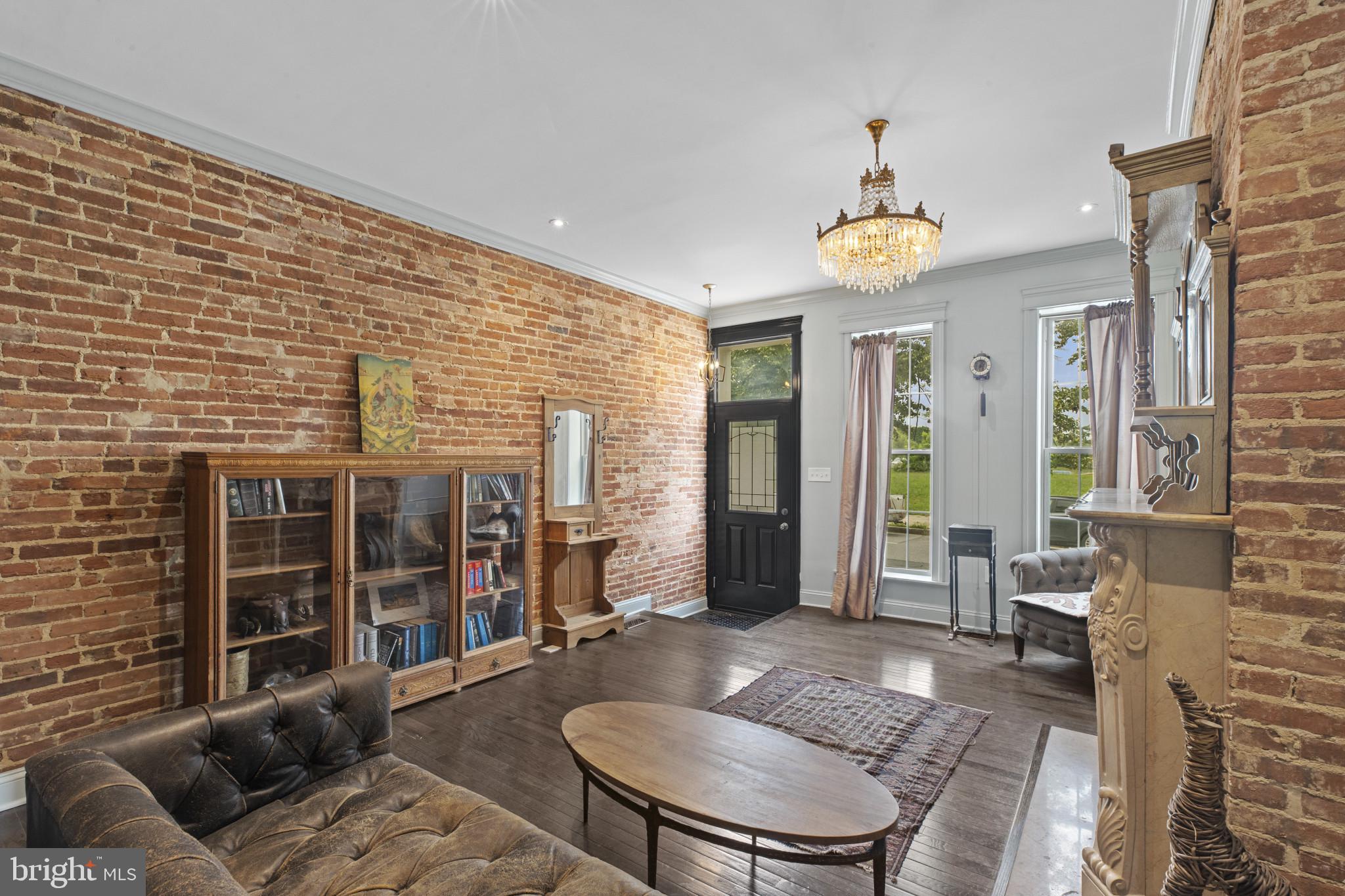 420 East Biddle Street Baltimore, MD 21202 - Photo 4 of 47 a living room with furniture a fireplace and a chandelier