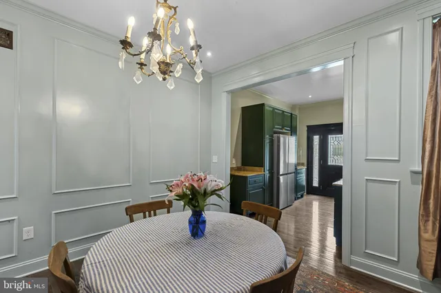 a dining room with furniture and chandelier